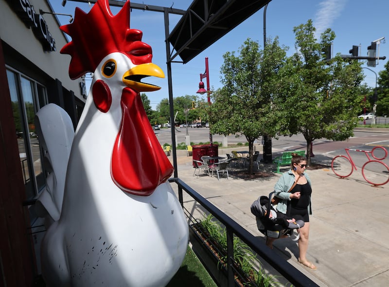 A woman walks with her child past the Crack Shack in the 9th and 9th area of Salt Lake City on Wednesday, May 31, 2023.