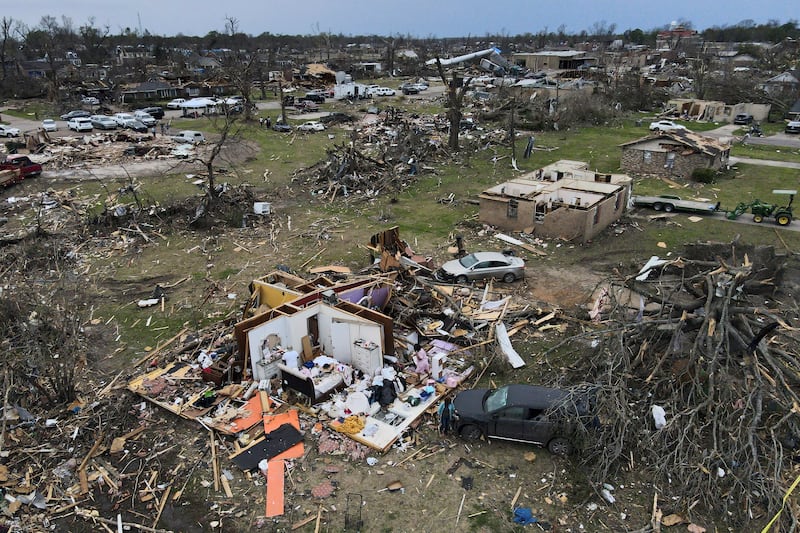 Debris is strewn about tornado damaged homes, Sunday, March 26, 2023, in Rolling Fork, Miss.