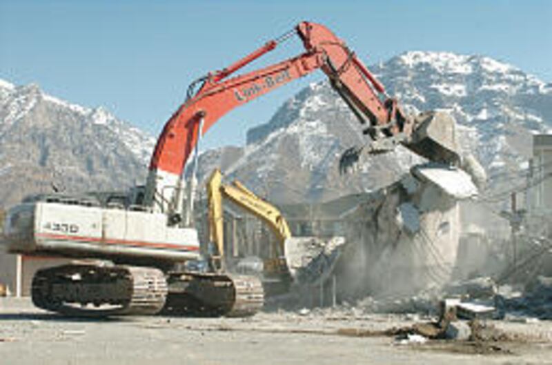 B.D. Barney Construction crews demolish the former Ream's grocery store. Student housing and retail stores will take its place.