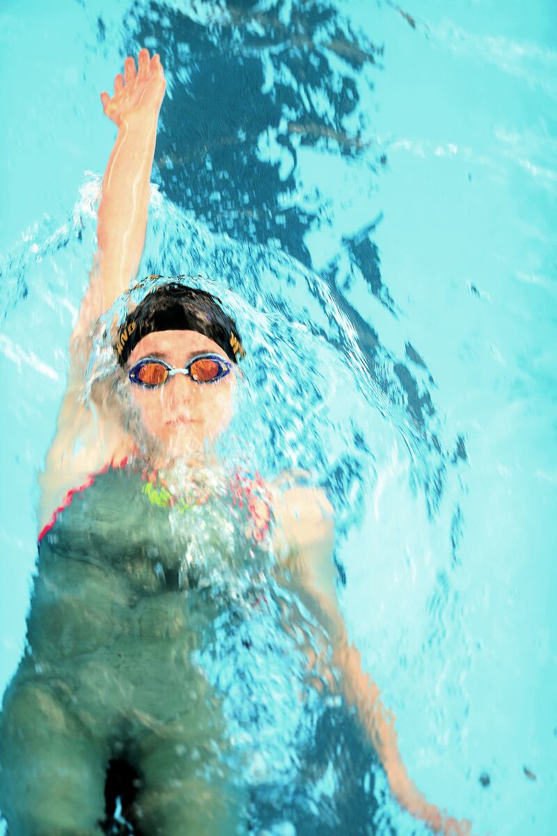 Desert Hills’ Kara Weiland competes in the 100 yard backstroke in the 4A state meet in Provo on Saturday, Feb. 9, 2019.