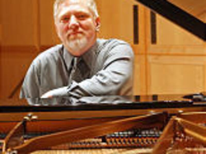 Pianist Dan Waldis at the keyboard in Libby Gardner Hall.