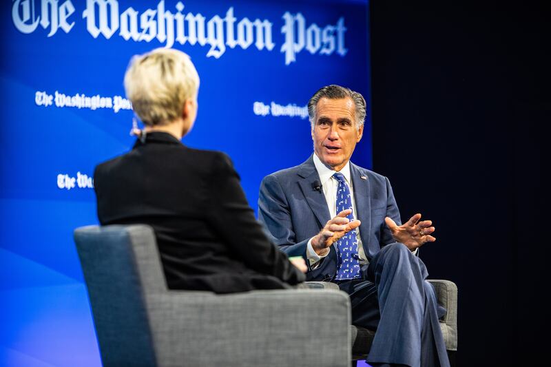 Sen. Mitt Romney, R-Utah, talks to Washington Post political reporter Leigh Ann Caldwell, left, during a Washington Post discussion on climate change.