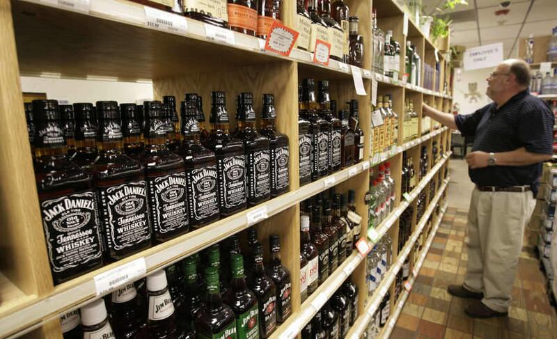 FILE - Assistant manager George Pence arranges the alcohol at a State liquor store in Salt Lake City, Utah, Thursday, May 27, 2010. Alcohol use among Utah high school seniors is up for the first time in more than a decade, according to a new state report.