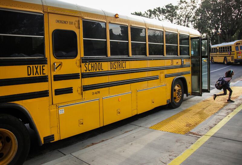In this Oct. 18, 2018 file photo, a student hops off the school bus at Dixie Elementary School in San Rafael, Calif. The beginning of this new school year is a fresh start and a fresh reminder that the job of effective oversight of public education doesn’