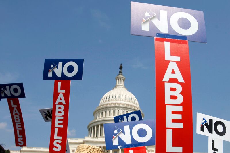 People with the group No Labels hold signs during a rally on Capitol Hill in Washington on July 18, 2011.