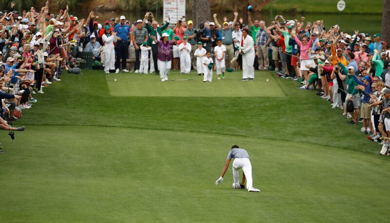 Tony Finau twists his ankle after reacting to his hole-in-one on the seventh hole during the Par-3 Contest at the Masters Wednesday, April 4, 2018, in Augusta, Ga.