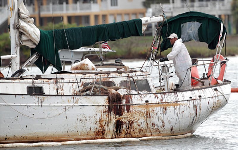 An oily sailboat heads out on a skimming mission in the Perdido Pass in Orange Beach, Ala., Thursday.