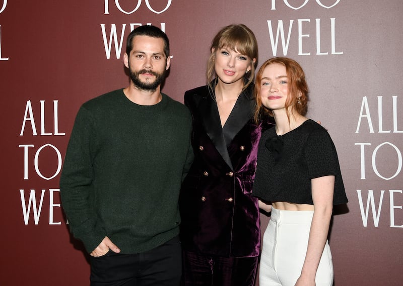 Actor Dylan O’Brien, writer-director Taylor Swift and actor Sadie Sink pose together at a premiere for the short film “All Too Well.”
