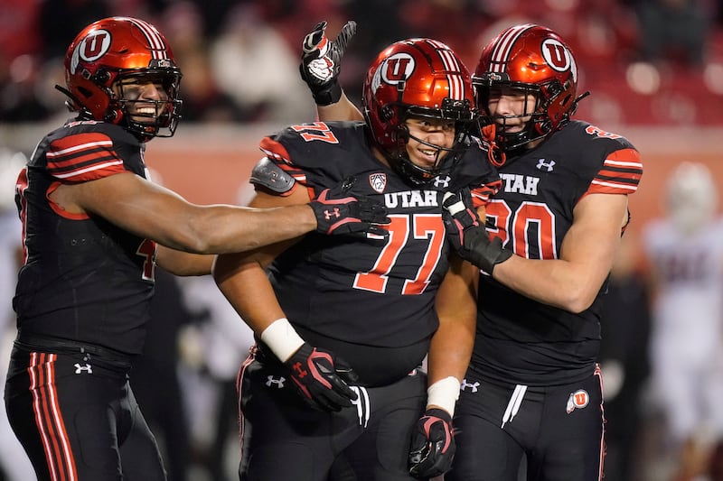 Utah defensive tackle Simote Pepa (77) celebrates with teammates.