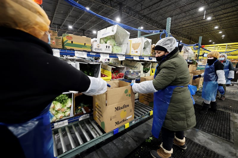 Workers fulfill orders at Misfits Market, a new warehouse and distribution facility in West Jordan.
