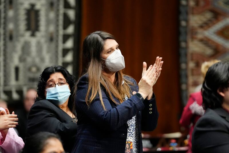 Stephanie Stahl Hamilton stands and applauds as Arizona Democratic Gov. Katie Hobbs gives the state address Monday, Jan. 9, 2023.