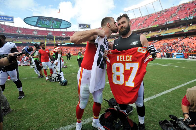 Kansas City Chiefs tight end Travis Kelce kisses his brother, Philadelphia Eagles center Jason Kelce after a game Sunday, Sept. 17, 2017.