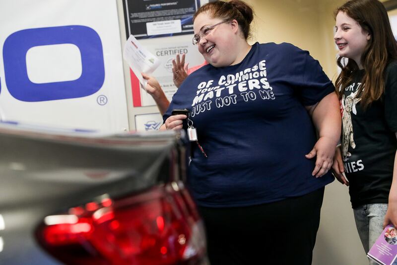 Darlene Lefevre and her daughter, Sophia, 10, react as they get their first glimpse of a 2015 Chrysler 200 that was donated to them at Higgins Body and Paint in West Valley City on Wednesday, June 27, 2018. Geico and Higgins Body and Paint, along with oth
