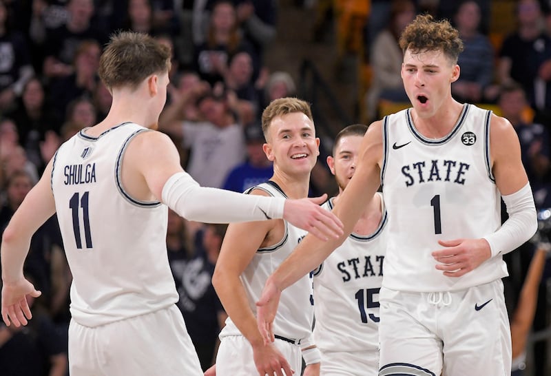 Utah State forward Taylor Funk (1) high fives with guard Max Shulga (11)