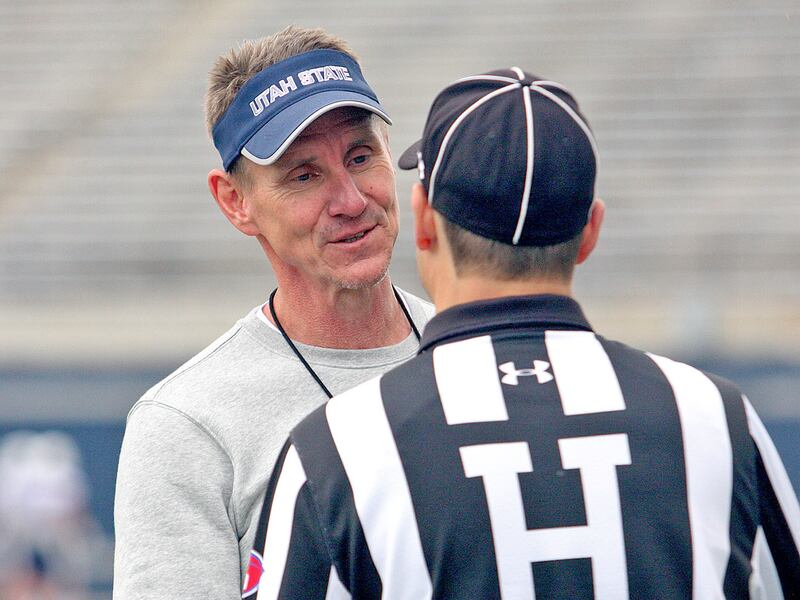 Utah State head football coach Gary Andersen chats with an official prior to the start of Saturday's Blue vs. White Spring Game at Maverik Stadium in Logan.