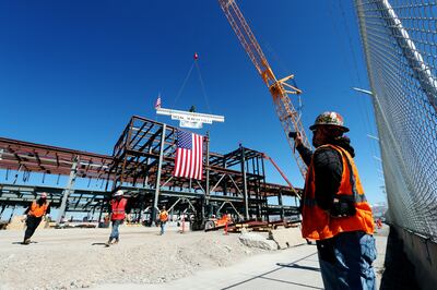 Workers watch as the final beam is placed on the north concourse at the Salt Lake City International Airport during a topping-off ceremony on Tuesday, March 19, 2019. The airport is currently undergoing a $3.6 billion airport expansion.