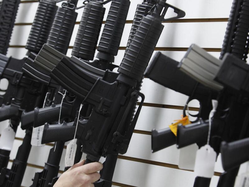 In this April 6, 2010, file photo, an Arizona made AR-15 is pulled from the display at Caswells Shooting Range in Mesa, Ariz.