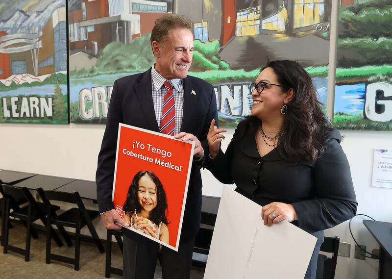 Rep. Jim Dunnigan, R-Taylorsville, and Senate Minority Leader Luz Escamilla, D-Salt Lake City, talk and pose for photos after a press conference to announce the expansion of a new State Children’s Health Insurance Program (CHIP) to cover children previously deemed ineligible due to their citizenship status at the Glendale Community Learning Center in Salt Lake City.