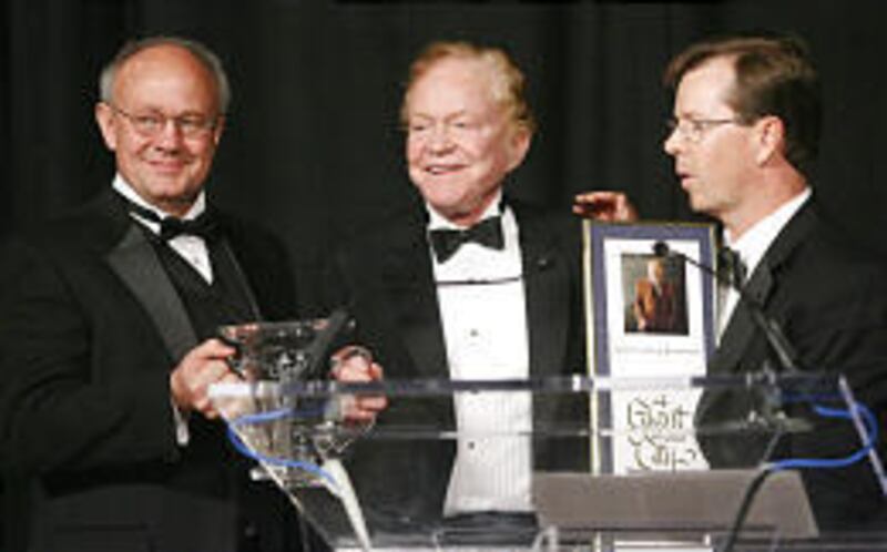 Lane Beattie, left, president/CEO of Salt Lake Chamber, and Clark Ivory, right, chamber chairman, honor James L. Sorenson Wednesday.