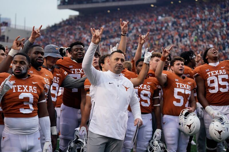 Texas coach Steve Sarkisian, the former BYU star QB, joins his team for the school song following their win over Baylor.