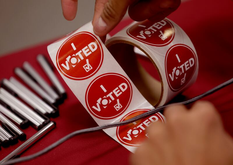 Voters are offered “I voted” stickers at the Salt Lake County Government Center in Salt Lake City.