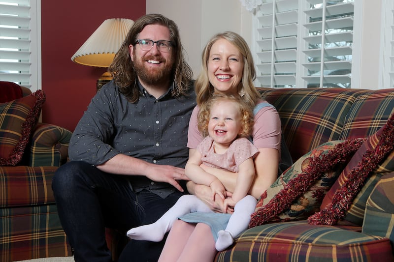 The Minert family — Steven, Tara and their daughter, Sage —
pose for a photo at their Centerville home on Sunday, March 4, 2018.