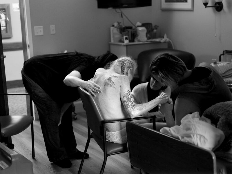 Caregivers comfort Paul Youngblood near the end of his life at The INN Between in Salt Lake City.