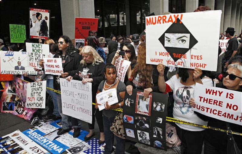 In this April 5, 2010 file photo, Michael Jackson fans gather outside the Los Angeles Criminal Court where Dr. Conrad Murray, the doctor charged in Michael Jackson's death, appeared for a procedural hearing in Los Angeles. Jackson's notoriously loyal fan
