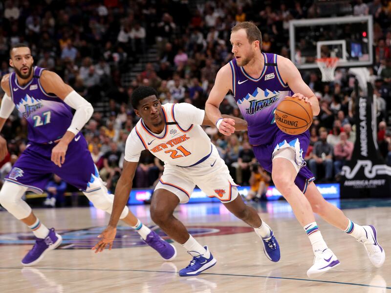 Joe Ingles drives around New York Knicks guard Damyean Dotson with Rudy Gobert trailing