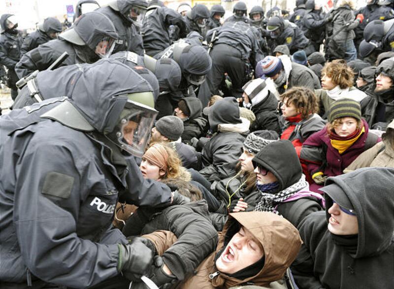 Police officers clear a blockade of demonstrators during a rally to remember the victims of Dresden's destruction at the end of World War II in Germany Saturday. Some 10,000 protesters formed a human chain in Dresden, determined to stop approximately 5,00