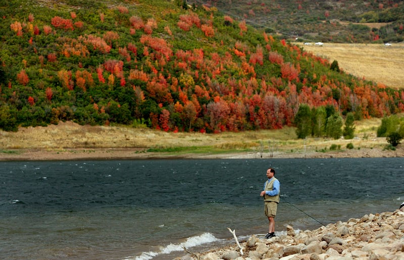 A fly fisherman enjoys the fall scenery as he fishes on Jordanelle Reservoir in Summit County, Utah.
