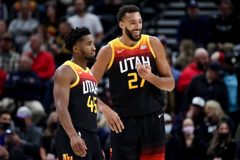 Utah Jazz guard Donovan Mitchell, left, and center Rudy Gobert talk on the court during game against the Philadelphia.