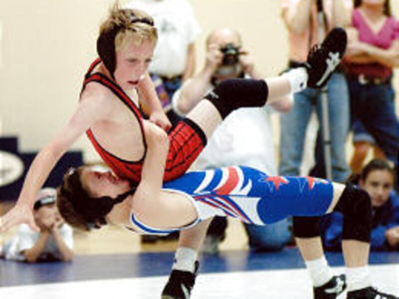 Mountain Top Wrestling Club member William Kilpack pulls down his opponent during Utah Summer Games action. His dad started the club.