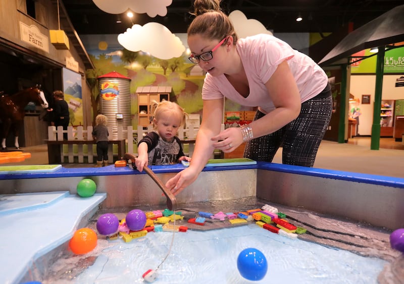 Jemma Palmer goes fishing with her mother Jessica Palmer at the Discovery Gateway Children's Museum in Salt Lake City on Wednesday, Dec. 19, 2018.