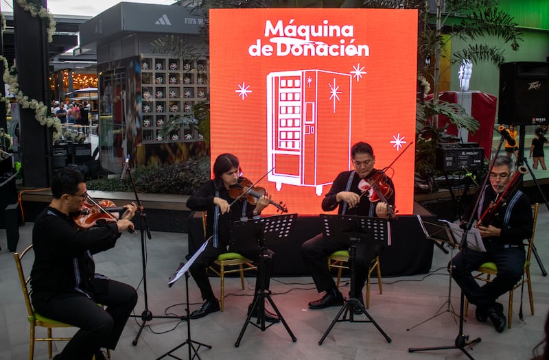 Local musicians play holiday music in celebration of the new Giving Machines that arrived in San Salvador, El Salvador, on Nov. 13, 2025.