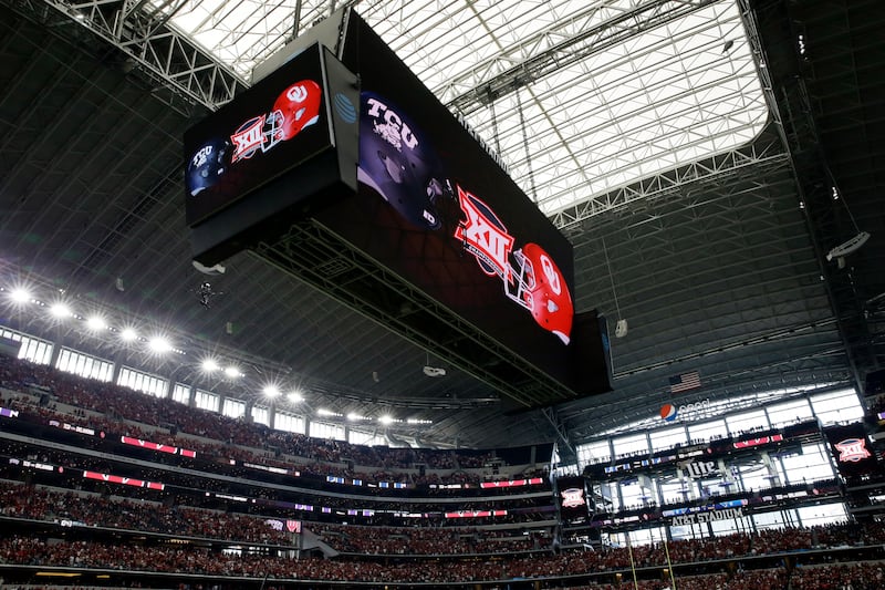 The video screen inside AT&T Stadium displays the TCU and Oklahoma logos during the Big 12 Conference championship game.