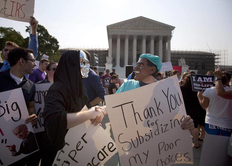 Demonstrators stand outside the Supreme Court in Washington, Thursday, June 28, 2012, before the court's ruling on health care.