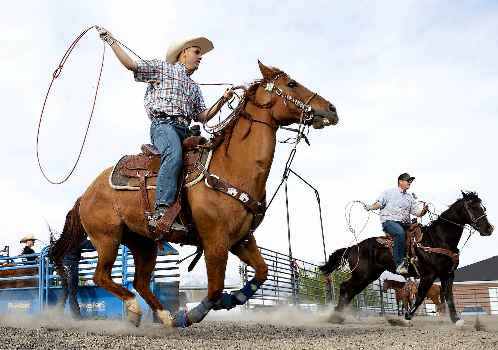 Ace Elegante and his father, Tony, practice roping in Bluffdale on Tuesday, May 9, 2023.
