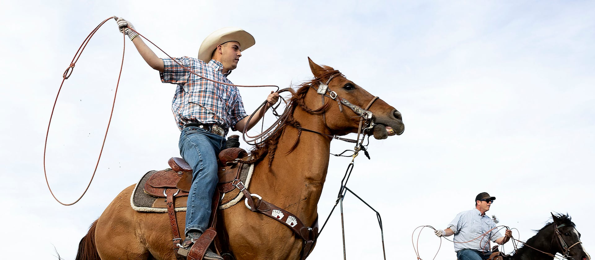 Ace Elegante and his father, Tony, practice roping in Bluffdale on Tuesday, May 9, 2023.