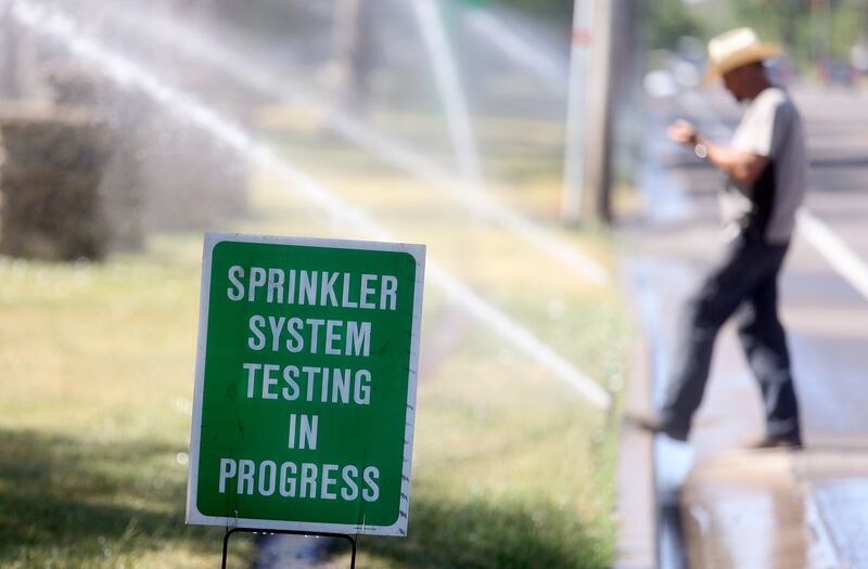 Gary Petit, a sprinkler irrigation repair tech for Salt Lake City’s Public Lands Department, repairs sprinklers.