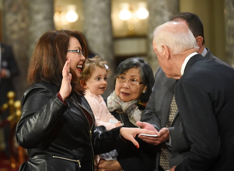 Vice President Joe Biden administers the Senate oath of office to Sen. Tammy Duckworth, D-Ill., as Biden and Duckworth's mother, Lamai, look at Duckworth's daughter, Abigail O'kalani Bowlsbey, on Jan. 3, 2017.