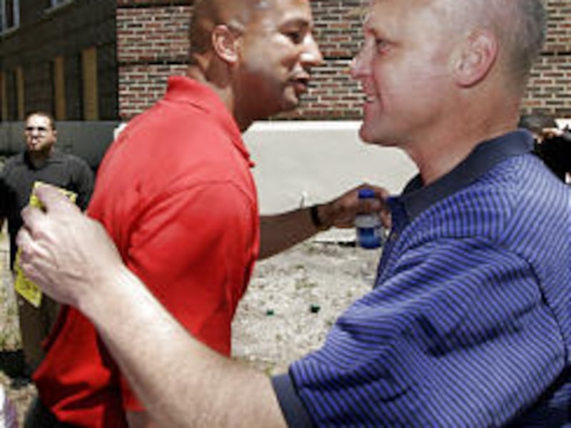New Orleans Mayor Ray Nagin, left, and Lt. Gov. Mitch Landrieu greet each other after Nagin voted in New Orleans on Saturday. Nagin has won a second term.