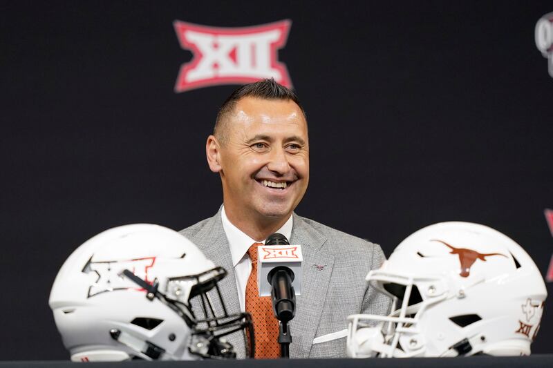 Texas coach Steve Sarkisian smiles before speaking to reporters at Big 12 football media days in Arlington, Texas.