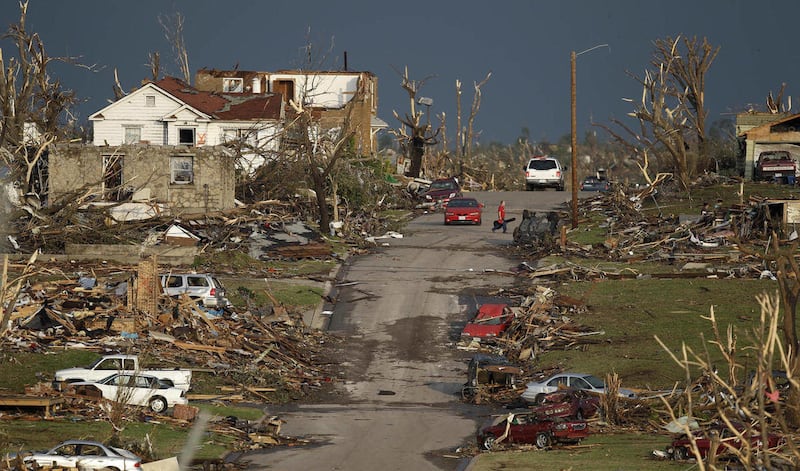 A man salvages a guitar from a severely damaged home in Joplin, Mo., Monday, May 23, 2011. A large tornado moved through much of the city Sunday, damaging a hospital and hundreds of homes and businesses and killing at least 89 people.