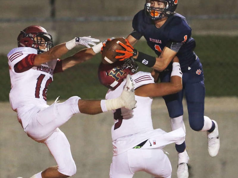 Brighton's Simi Fehoko out jumps Herriman's Noah Vaea and Tanner Rosenhan for the ball to score a touchdown as Brighton and Herriman play Friday, Aug. 21, 2015, at Brighton. Brighton won 23-14.