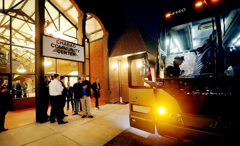 Attendees of Interfaith Month bus tour board a bus after a tour of Chabad Lubavitch and head for the Islamic Bosnian Mosque on Tuesday, Feb. 27, 2018.