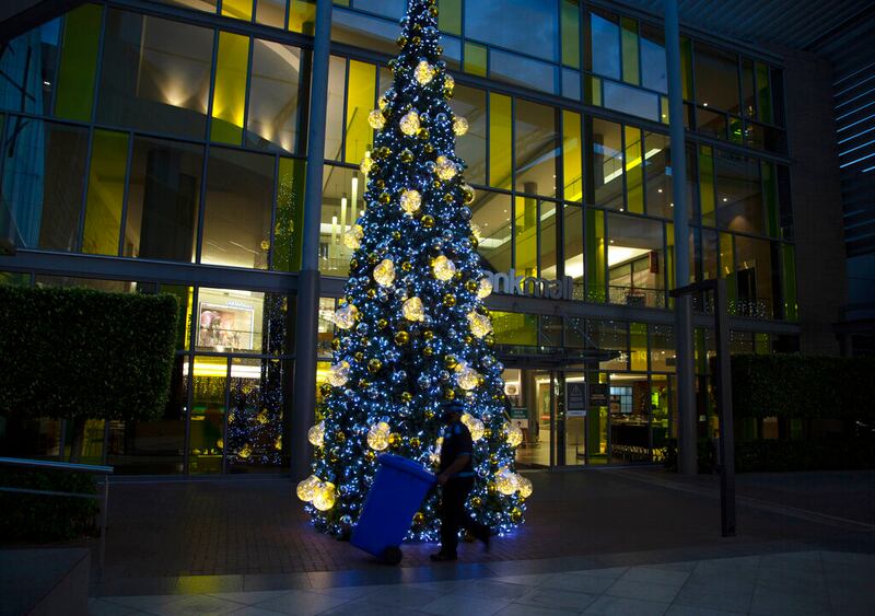 A worker at a Christmas tree at a Johannesburg Mall.