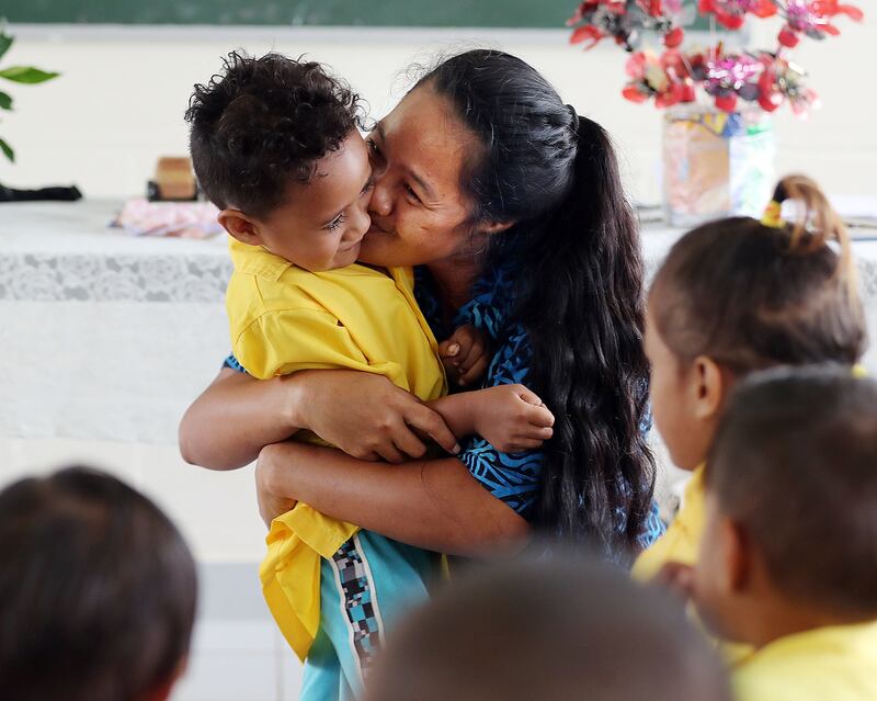 Teacher Sia Osa hugs her son Blesspolsi during an activity at Foundational Learning preschool at the Siumu Ward in Siumu, Samoa, on Thursday, May 16, 2019.