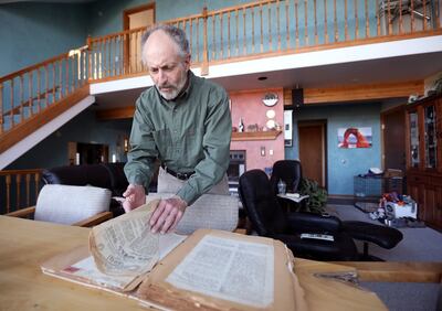 Scott Zuckerman, MD, author of "Dreams of My Comrades," goes through an old scrapbook of letters and memorabilia from a World War II veteran at home in Park City on Monday, May 7, 2018. The veteran is the subject of "Dreams of My Comrades."