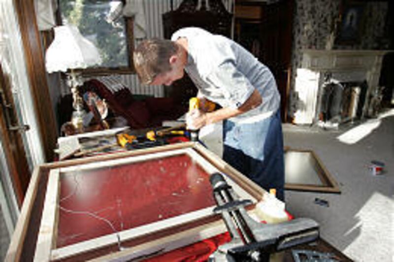 Corey Harker, 17, works on a custom frame in Highland. His mother's business builds frames from wood salvaged from the former Hotel Utah.